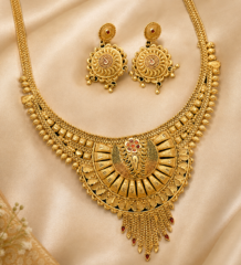 Antique gold plated necklace and earring combo set with paisley pendant, red meenakari detailing and chain tassel drops